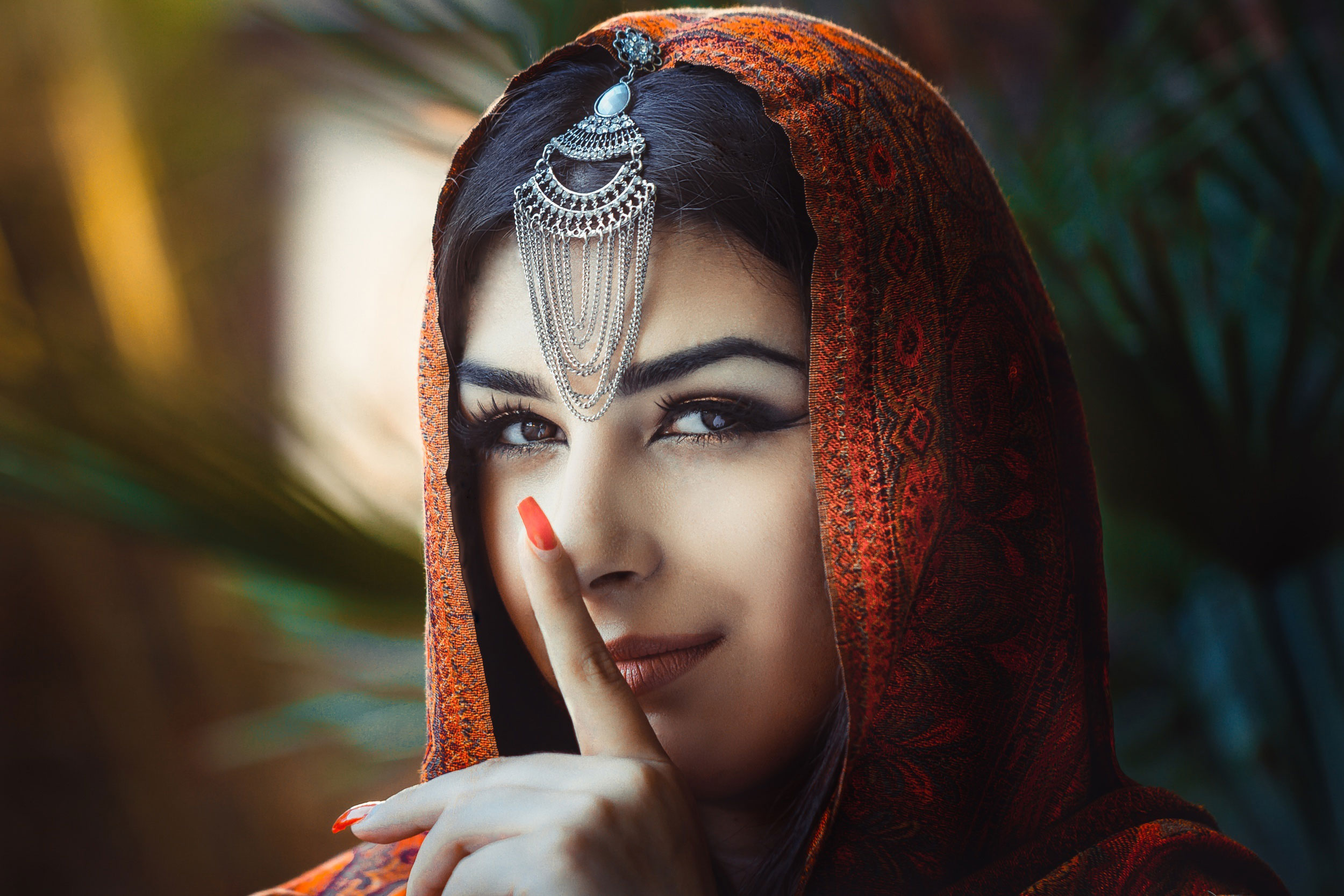 A beautiful woman wearing traditional Indian dress and a red veil